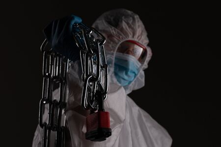 Front liner personnel hand tied with metal chain, coronavirus conceptの写真素材