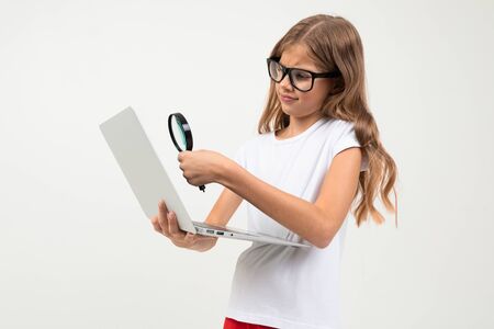Beautiful caucasian teenager girl in white t-shirt and red trousers with glassesの写真素材