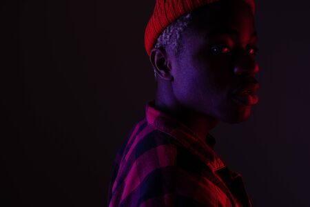 portrait of a stylish handsome american black man in neon light.の写真素材