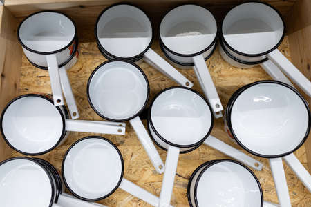 enamelled metal dishes ladle for heating water.