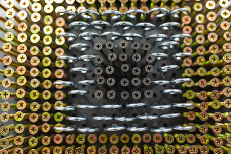 golden and silver strong nails close-up in a hardware store.
