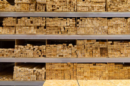 shelves of a hardware store lined with stacks of wooden boards.の写真素材