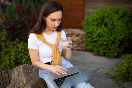 business woman working at the computer on the street.