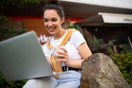 business woman working at the computer on the street.の写真素材
