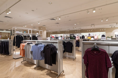 Modern fashionable brand interior of clothing store inside shopping center.