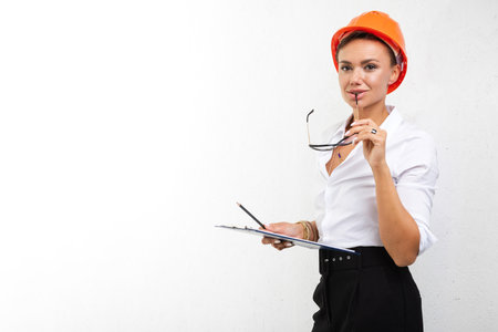 woman builder in helmet on white isolated backgroundの写真素材