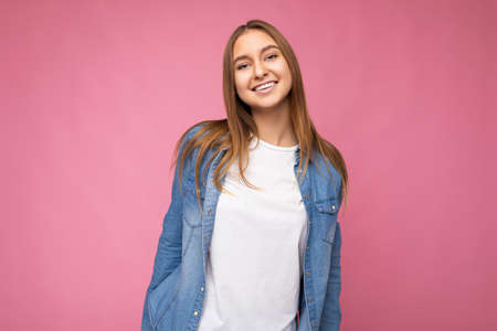 Shot of smiling happy attractive dark blonde woman with sincere emotions isolated on background wall...