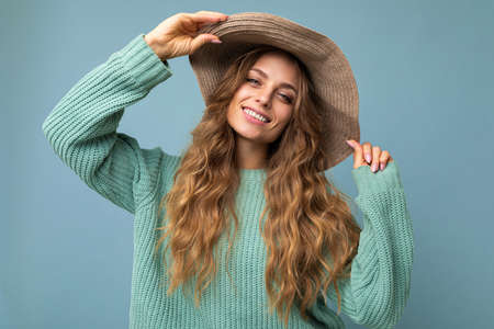 Young beautiful cute curly blonde woman with sexy expression, cheerful and happy face wearing trendy...