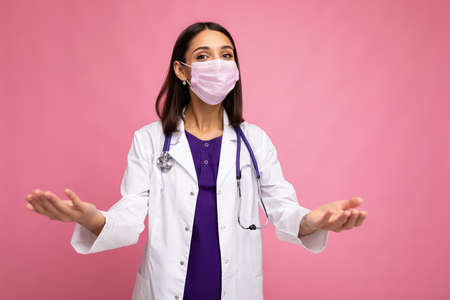 healthcare and doctors concept. Portrait of professional confident young european doctor in medical mask and white coat, stethoscope over neckの写真素材