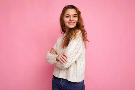 Portrait of positive cheerful fashionable woman in formalwear looking at camera isolated on pink background with copy spaceの写真素材