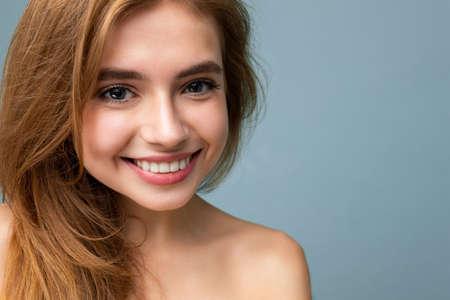 Closeup photo of young smiling beautiful dark blonde woman isolated on background with copy space....