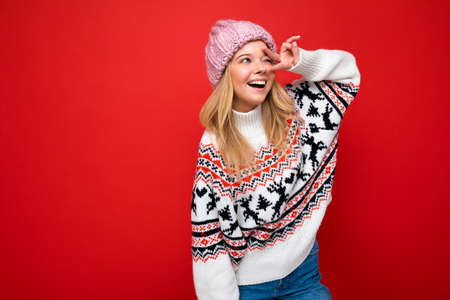 Beautiful positive happy young blonde woman isolated over colourful background wall wearing casual...
