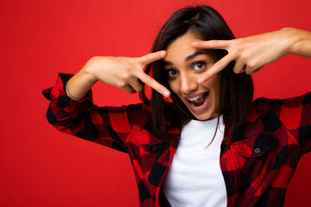 Portrait of young happy positive surprised attractive brunette female teenager with sincere emotions...