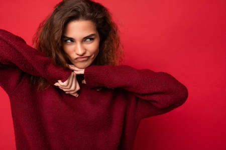 Photo of young funny self-confident beautiful brunette curly woman with sincere emotions wearing...