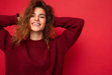 Photo of beautiful positive smiling adult woman wearing stylish clothes standing isolated on colorful background with copy space looking at cameraの写真素材