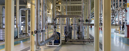 Panoramic photo of pipes and tanks. Chemistry and medicine production. Pharmaceutical factory