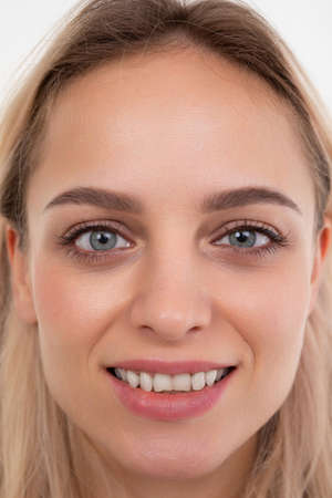 close-up portrait of a beautiful blonde with straight white teeth