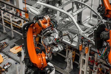 Car bodies are on assembly line. Factory for production of cars. Modern automotive industry....