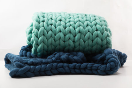 two plaids of large coarse knit on a white background from natural sheepskin