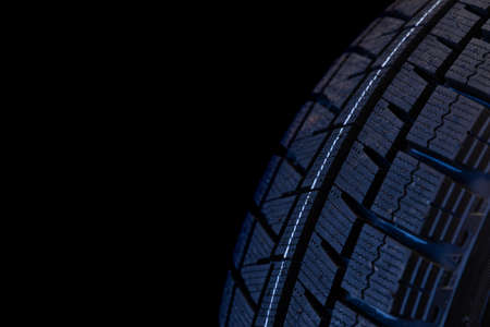winter tire tread on black background close upの写真素材