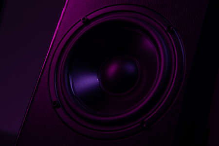 speaker close-up on black background with atmospheric lightingの写真素材