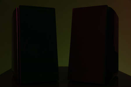 pair of studio acoustic monitors with fabric grills on a dark backgroundの写真素材