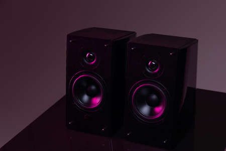 a pair of speakers for listening to music on a dark background with purple-Lilac backlighting, professional studio monitors for a sound engineerの写真素材