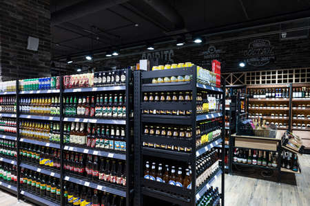 Minsk, Belarus - Nov 25, 2021: Photo of the wine and spirits department in a grocery store with food. Shop and shopping concept. Alcohol and bottlesのeditorial素材