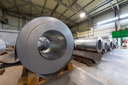 Closeup photo of metal tile for roof in metallic forming machine production line in factory. Cold rolled steel coils at the plantの写真素材