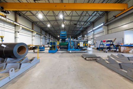 Metal sheet profile forming machine, process of making steel tile for roof, industrial manufacturing. Background of plant and factoryの写真素材