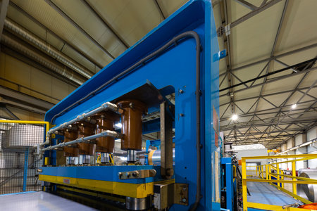 Photo of steel roofing forming machine. Industrial machine for metal sheet roof coils cut. Process...