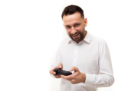 young stylish man in a white shirt with a joystick in his hands invites to play a video game