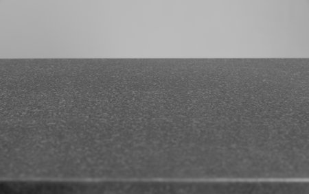 metal gray table surface for background copy-space on gray wall backgroundの写真素材