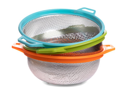 a set of sieve on a white background, colanders inserted into each other