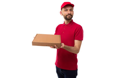 delivery courier in red uniform holding a box of pizza