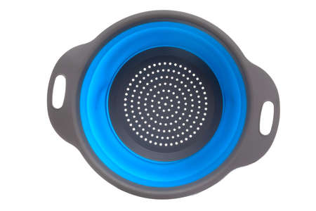 plastic gray colander with blue insert on white background, top view