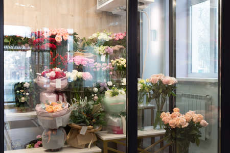 refrigerator in a flower shop with bouquets on the shelvesの写真素材
