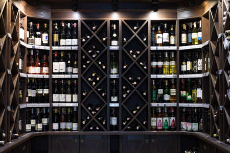 Minsk, Belarus - Dec 20, 2021: wine cabinet in the interior of a shop selling elite alcohol