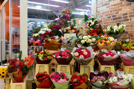 Minsk, Belarus - Dec 20, 2021: showcase of a florist salon with a lot of bouquets in a packageのeditorial素材