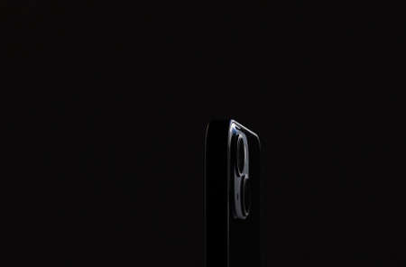 two large smartphone cameras close-up on a black background