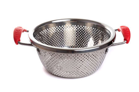 metal chrome colander with red handles on a white isolated backgroundの写真素材