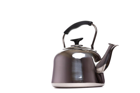 a large metal kettle for an electric stove on a white isolated backgroundの写真素材