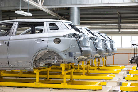 Photo of automobile production line. Welding car body. Modern car assembly plant. Auto industry. High-tech factoryの写真素材