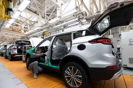Minsk, Belarus - Dec 15, 2021: Car bodies are on assembly line. Factory for production of cars....