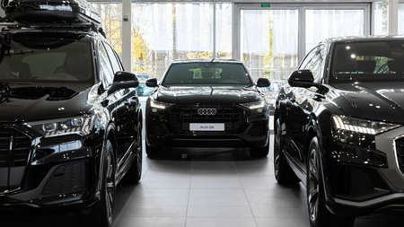 Minsk, Belarus - Jan 05, 2022: interior of audi car showroom with three black expensive saucy SUVs...