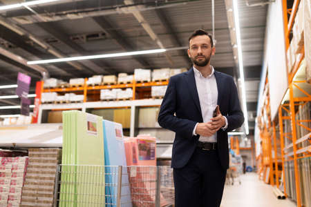 sales manager at a hardware store in the flooring department. sale of parquet, laminate and linoleum, carpetの写真素材