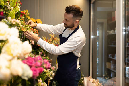 businessman florist in fridge with fresh bouquetsの写真素材