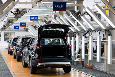 Photo of automobile production line. Welding car bodies. Modern car assembly plant. Auto industryの写真素材