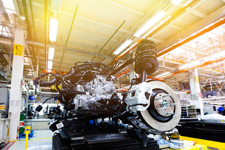 Photo of car bodies are on assembly line. Factory for production of cars. Modern automotive...