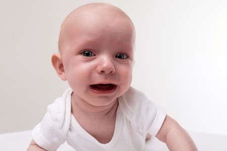 baby close-up on a white background cryingの写真素材